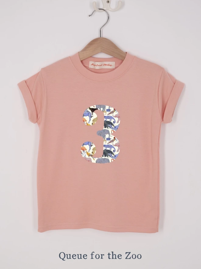 a pink t-shirt appliquéd with a number 3 in a zoo animal Liberty print