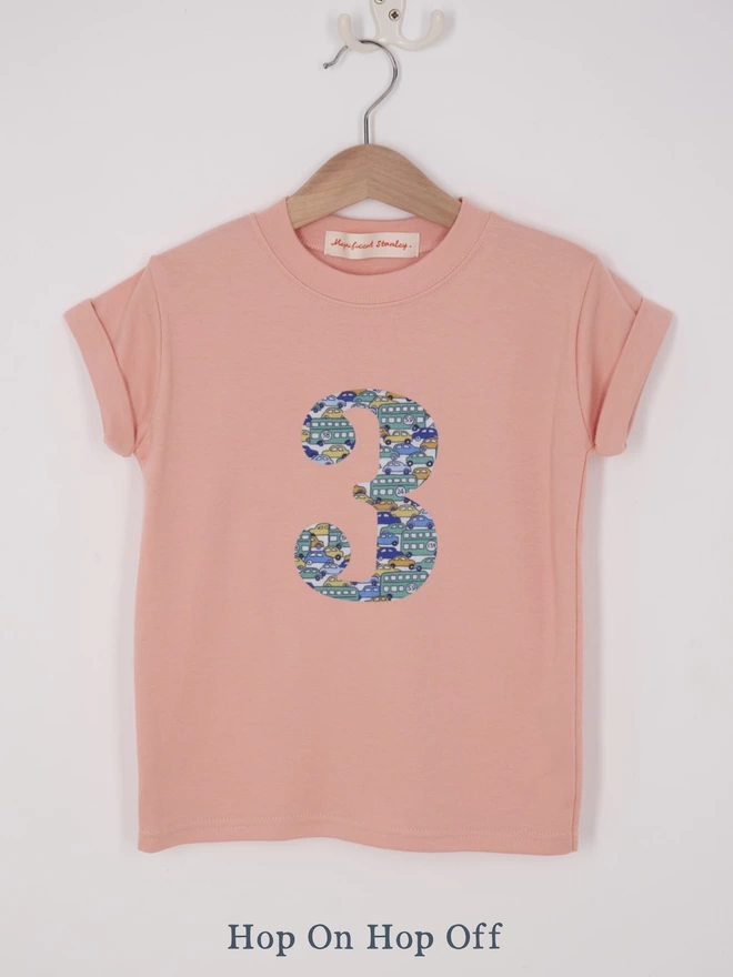 a pink t-shirt appliquéd with a number 2 in a vintage car Liberty print