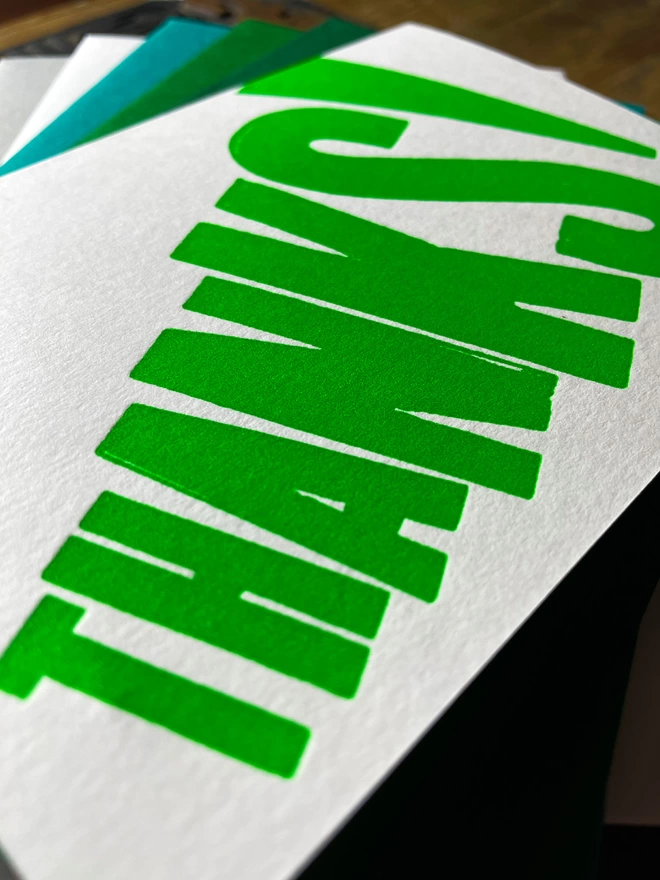 Thanks! A vibrant thank you typographic letterpress card with deep impression print using fluorescent green, with a range of colourful envelopes. Slight print variations adding to the style anding to the charm of this handmade greeting card.