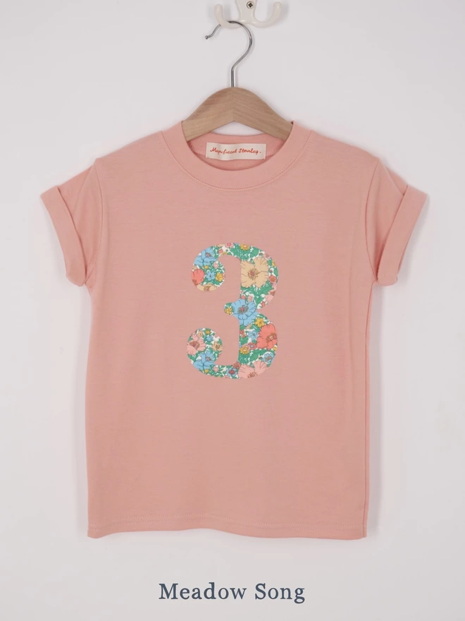 a pink t-shirt appliquéd with a number 3 in floral Liberty print