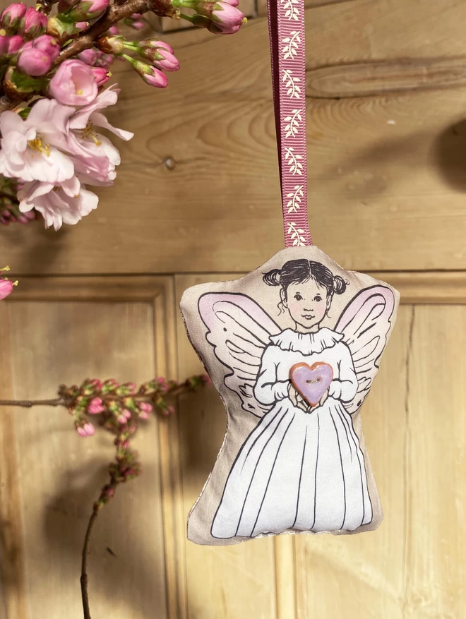 pretty fairy hung in front of a wooden door