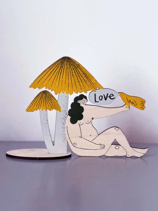 A free standing artwork, a mushroom nymph feeding a bird
