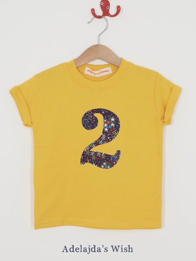 a yellow t-shirt with a Liberty star print number 2 on front