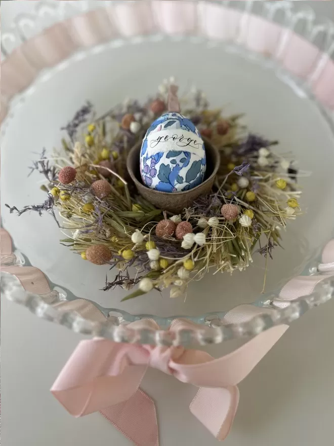 Personalised Liberty fabric decorative egg in Easter nest in a glass bowl with pink ribbon
