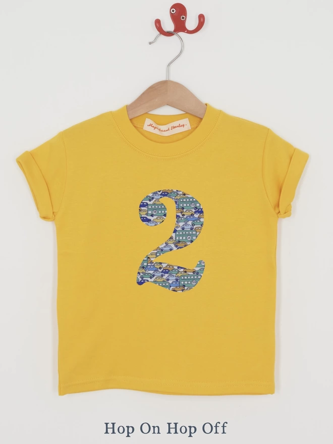a yellow t-shirt with a vintage cars print number 2 on front