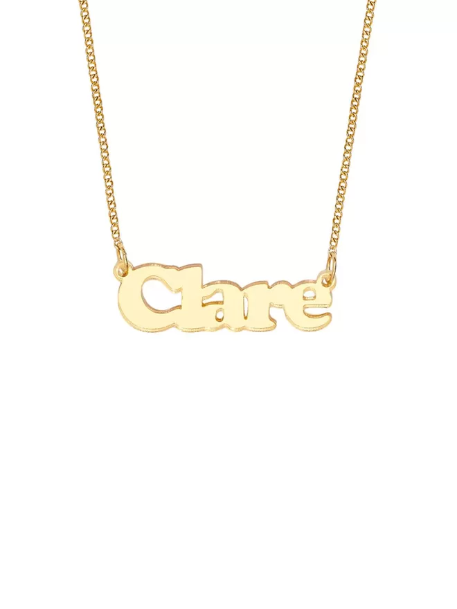 Personalised Name Neckace from Tatty Devine. The Necklace is the word Clare laser cut from Deluxe Gold Mirror Acrylic on a gold-plated chain.