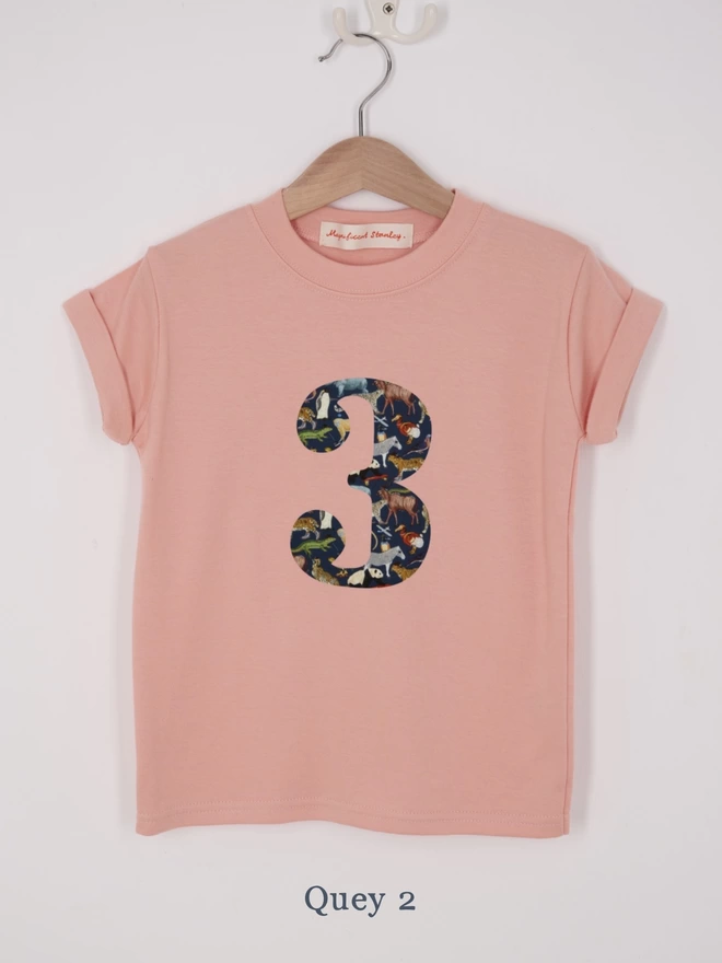a pink t-shirt appliquéd with a number 2 in a zoo animal Liberty print