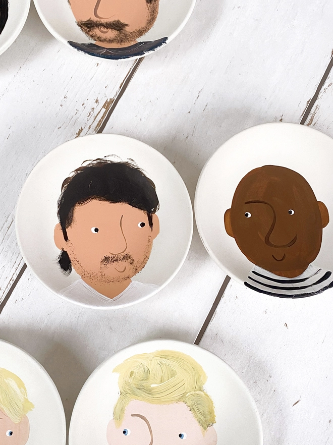 two plates painted with portraits 