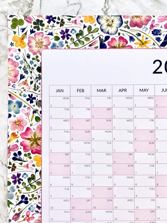 Vertical Yearly Wall Planner with Pink Weekend Highlights and Pretty Pressed Flowers. Garden Themed.