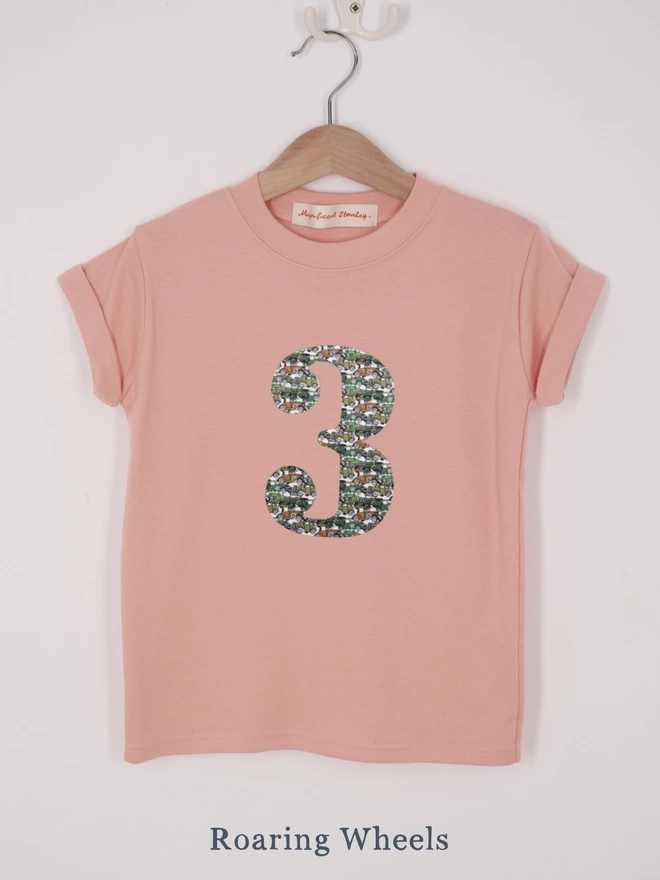 a pink t-shirt appliquéd with a number 2 in a vintage car Liberty print