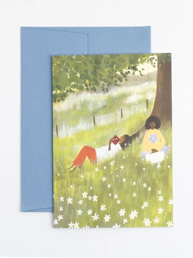 An illustration of two women reading under a tree, surrounded by a field of daisies in the glowing evening light.