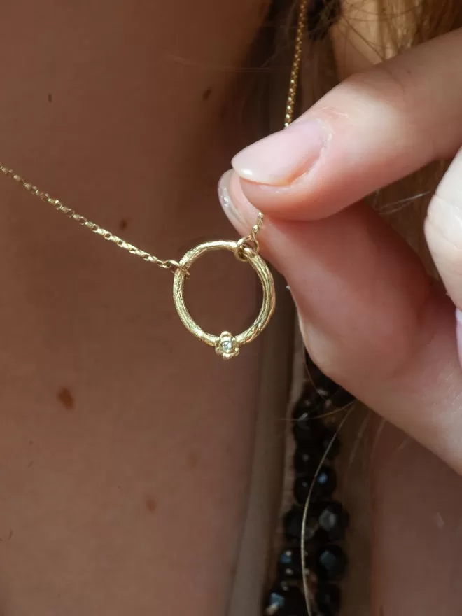 Karma Circle Diamond Necklace seen on a woman 