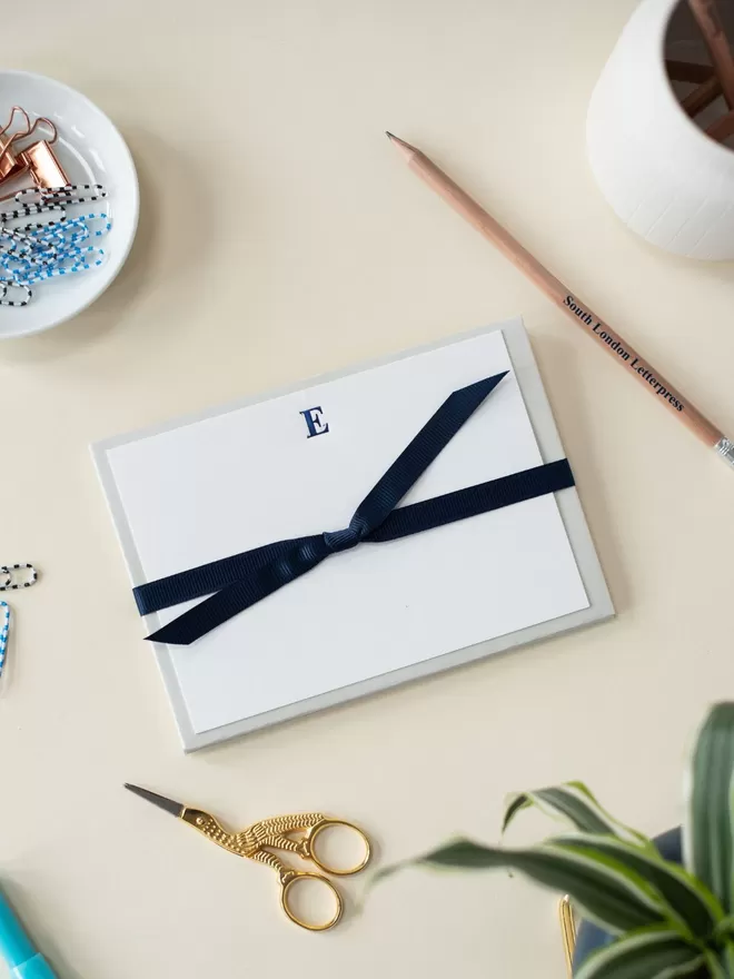 South London Letterpress Navy Blue Initial notecards seen tied up with a navy ribbon.