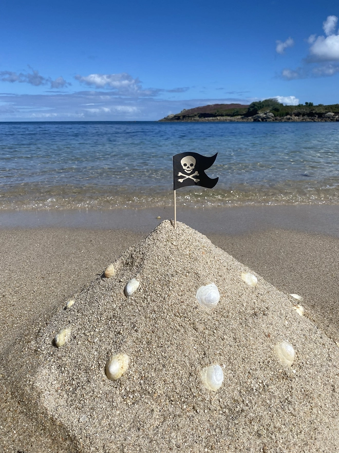 A Pirate flag in a sandcastle