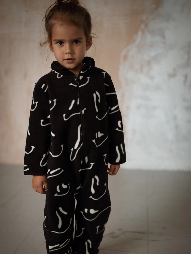 Another Fox Grin Polar Fleece All In One seen on a child against a distressed wall.