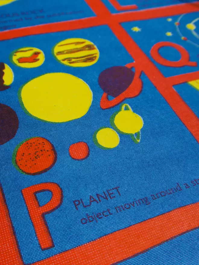Close-up, detailed shot: letter P with yellow and red planets