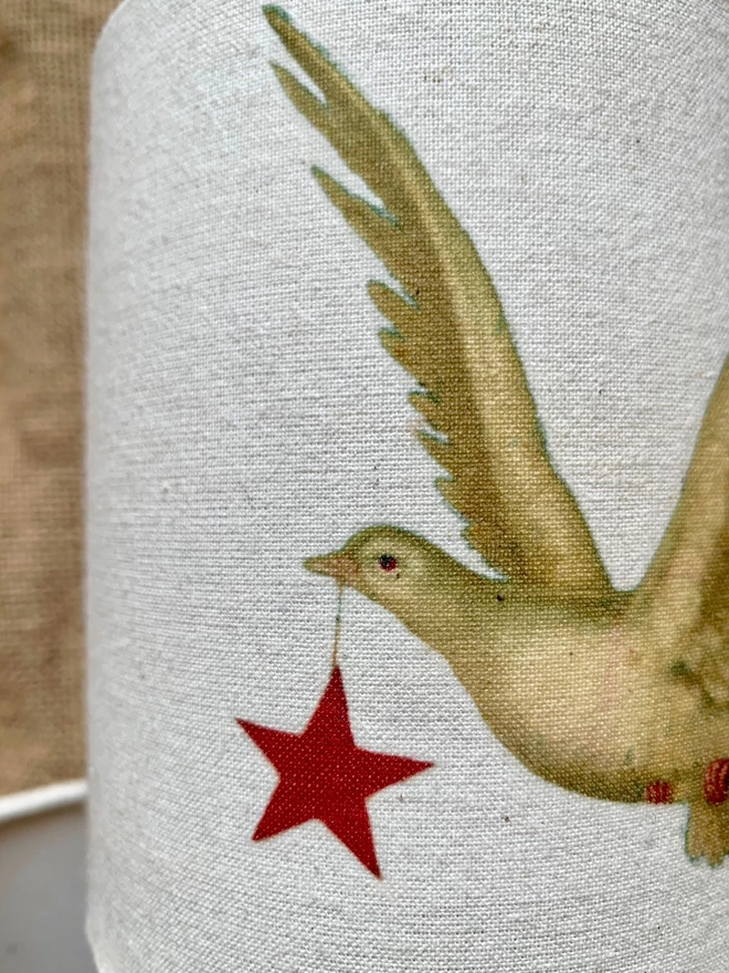 Fabric with a dove carrying a star