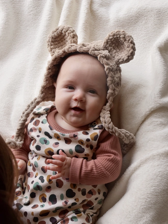 Baby wearing handmade animal earred bonnet