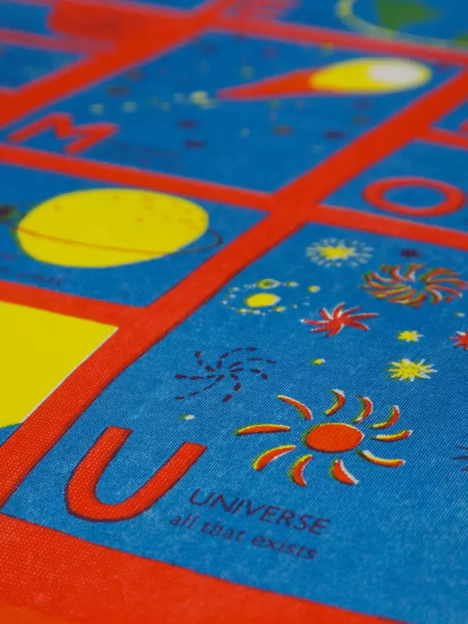 Close-up, detailed shot: letter U with red and yellow stars describing universe
