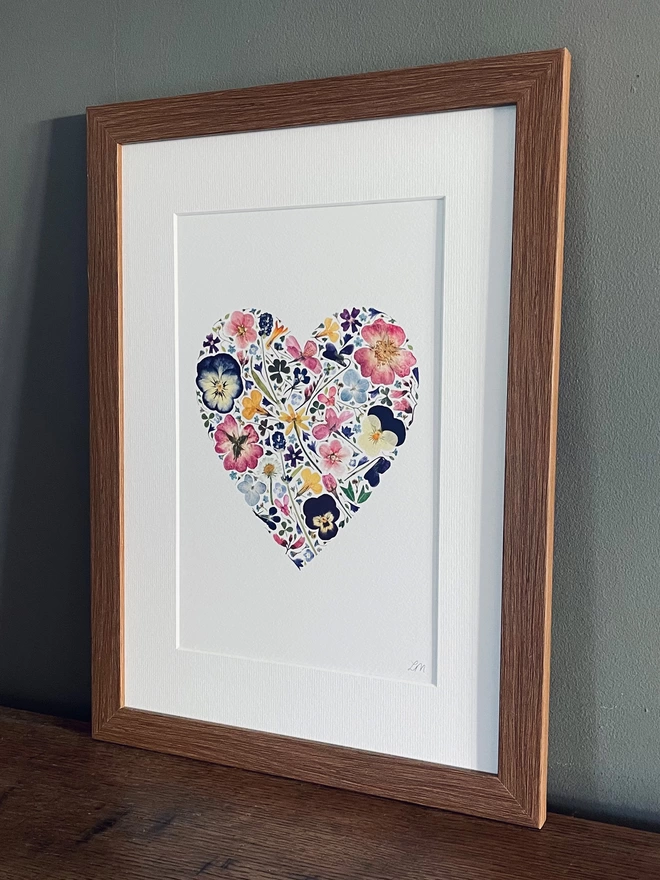 Pressed flower art print in the shape of a romantic heart.