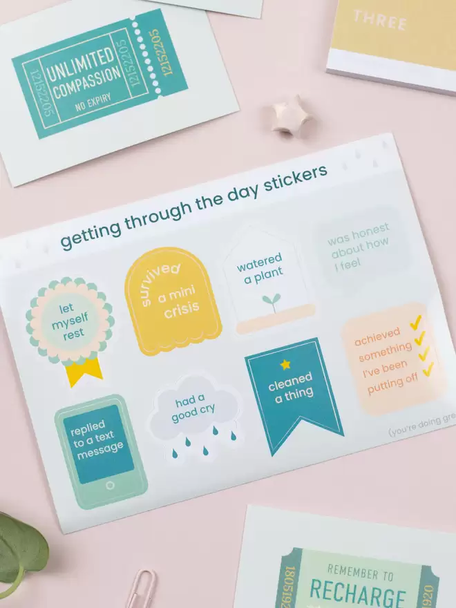 An A6 sheet of 8 stickers with the title 'Getting through the day stickers'. Each sticker has a different shape and achievement statement.