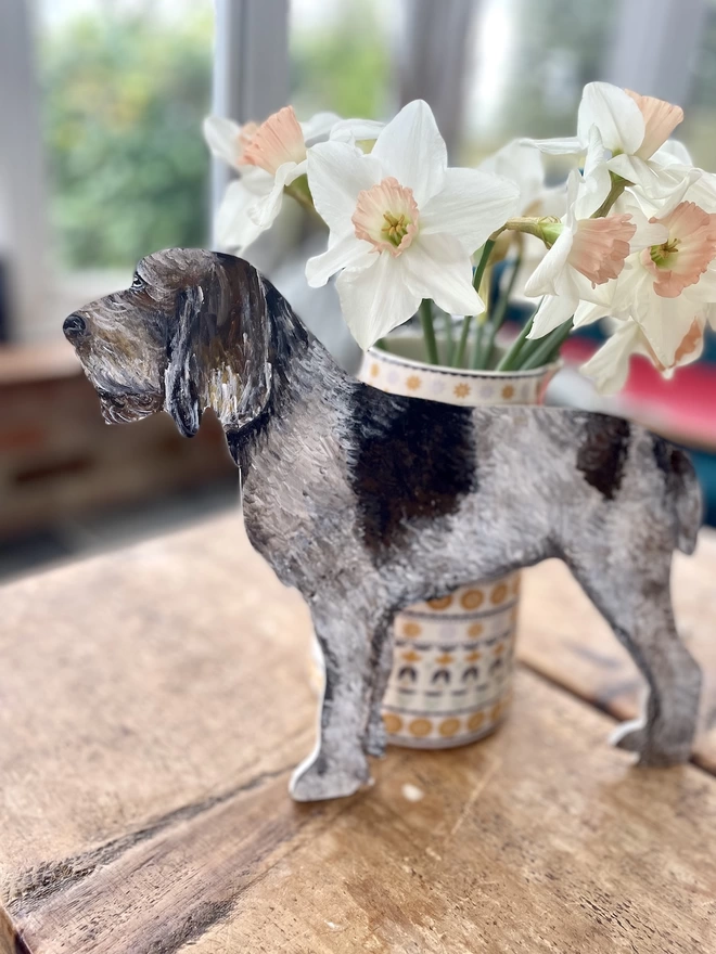 Italian Spinone wooden handpainted dog portrait stood up next to a jar of flowers