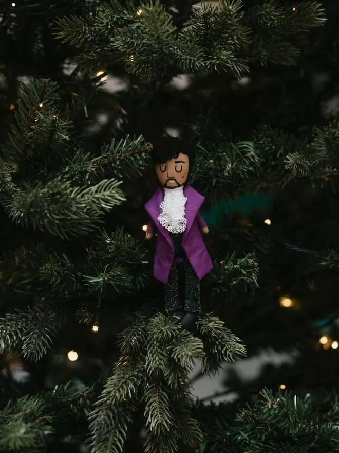 Prince standing in a Christmas Tree