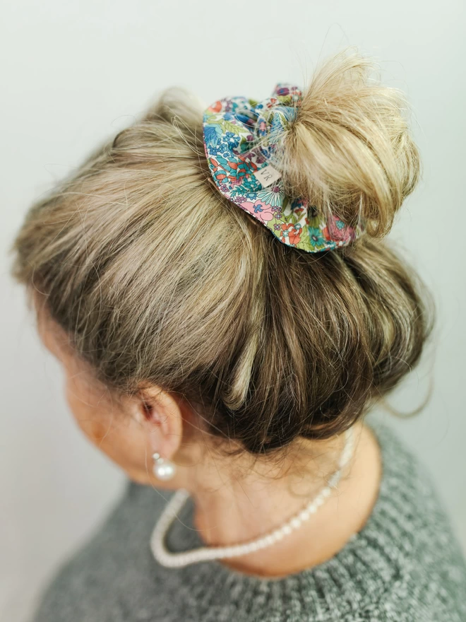 model wearing liberty hair scrunchie and pearls
