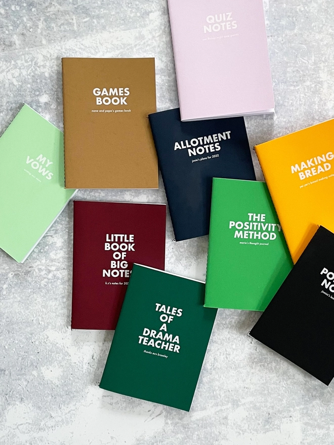 A collection of colourful pocket notebooks with personalised text