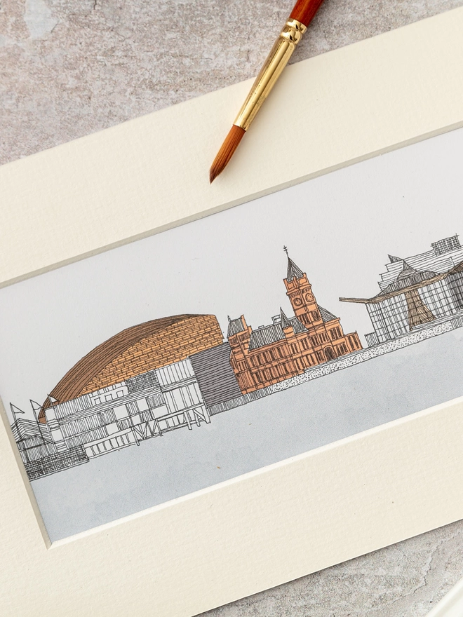 Print of detailed pen and watercolour drawing of Cardiff Bay buildings and waterfront, in a soft white mount