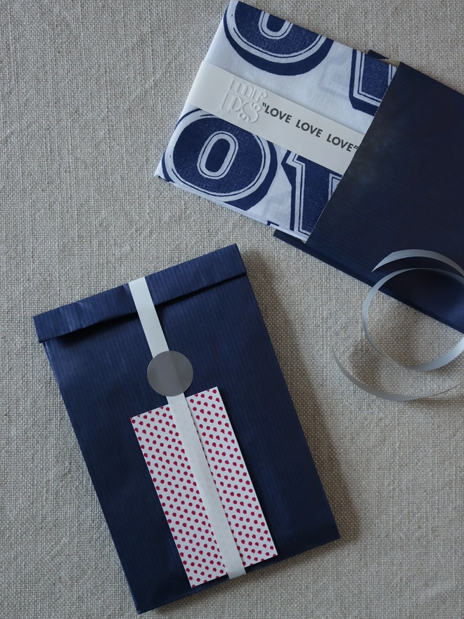 A Mr.PS LOVE hankie with optional gift wrapping; navy paper, white ribbon and patterned gift card