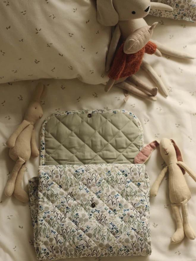 A changing mat with soft toy bunnies
