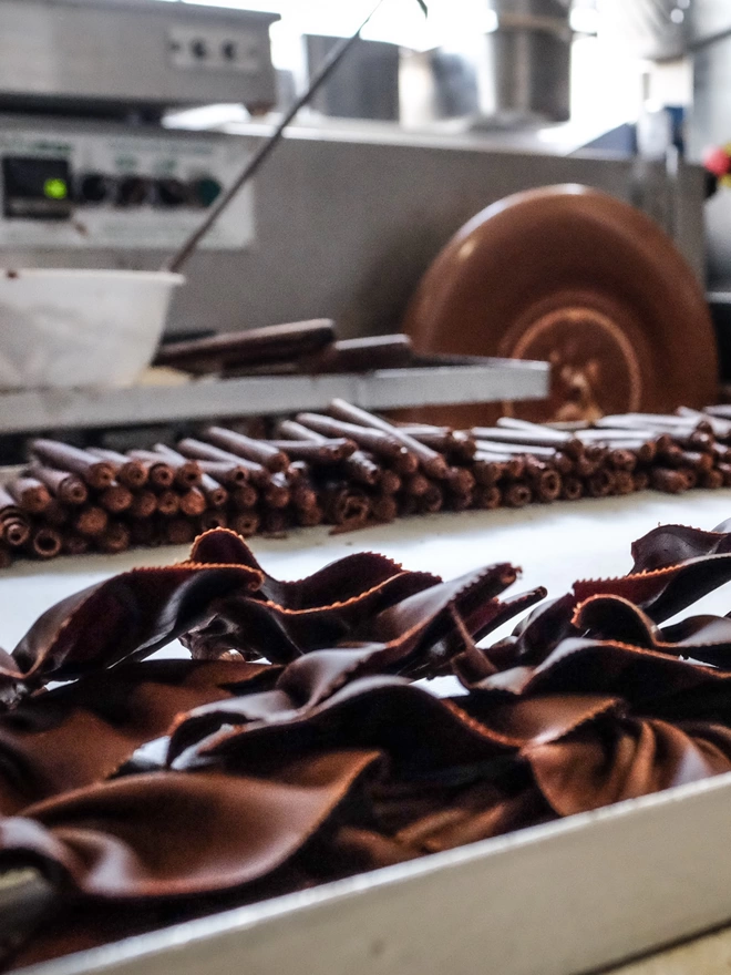Chocolate tempering machine with examples of chocolate fans and rolls