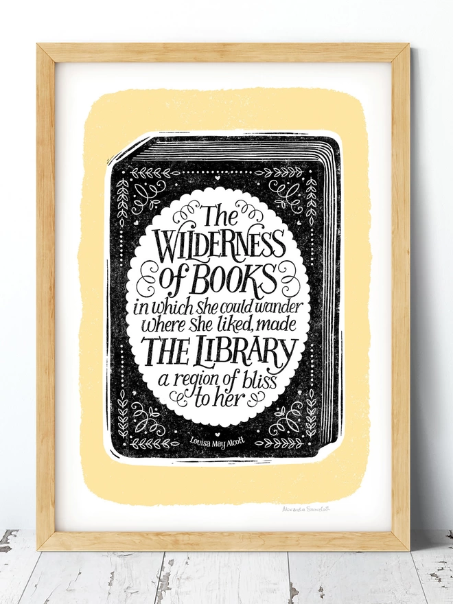 A hand lettered book quote print on a black book cover with yellow background
