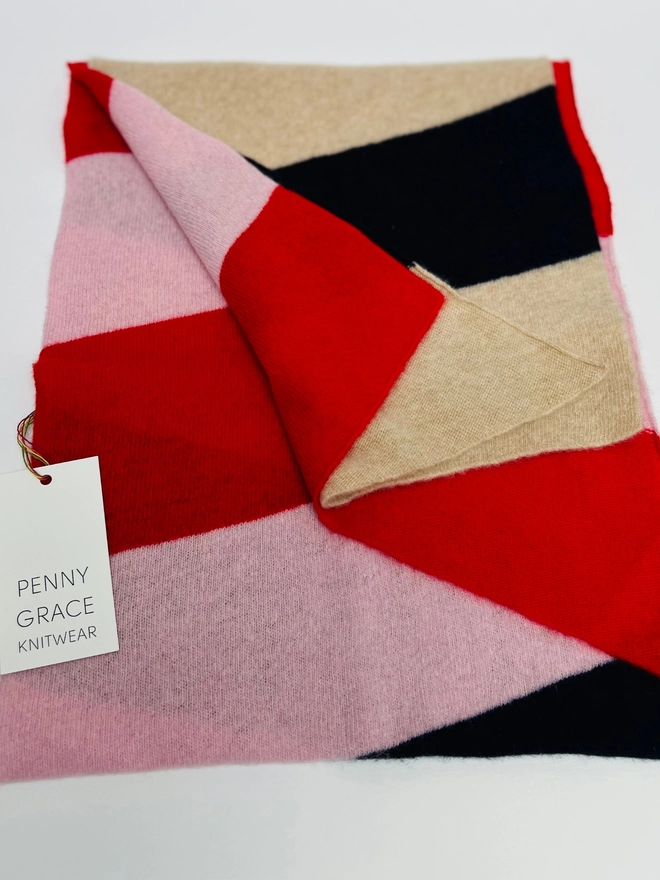 Red pink navy scarf shown folded 