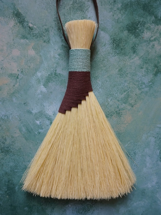 Handmade tampico brush with brown and light blue hemp cord binding