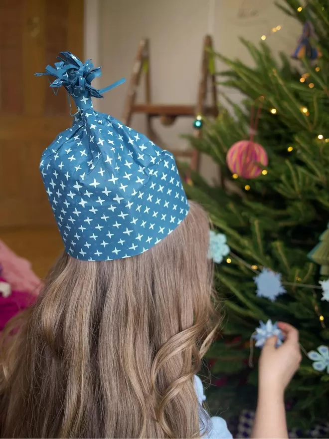 East end press party hat seen on a woman hanging christmas decorations