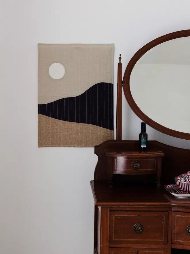 Moonrise Quilt Hanging On Wall Next To Dressing Table