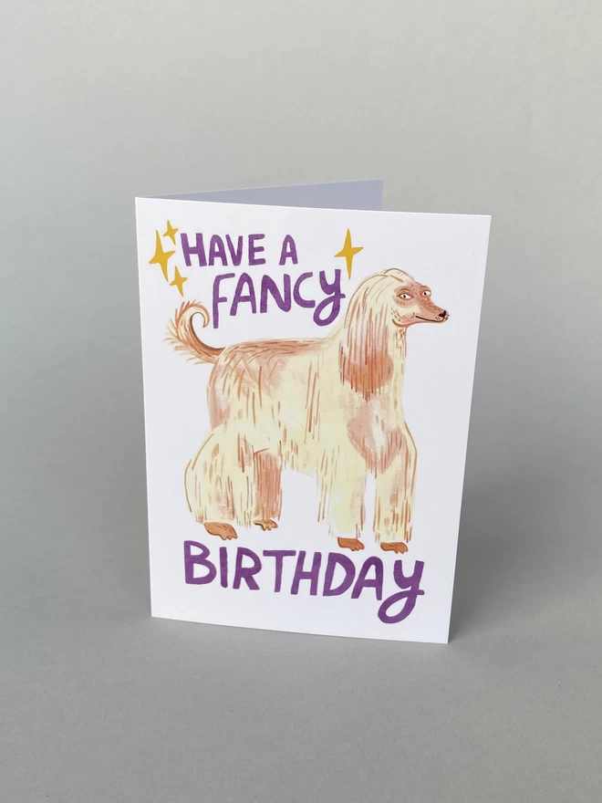 Illustrated birthday card with blonde afghan hound that reads have a fancy birthday, A6 greeting card for dog lovers