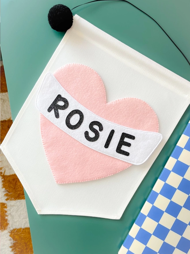 Rosie hear banner on a Green table
