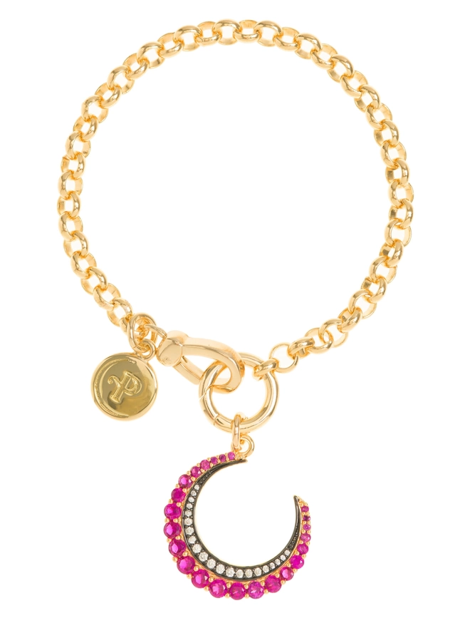Pink crescent moon stone set charm hanging from a gold belcher chain bracelet on a white background