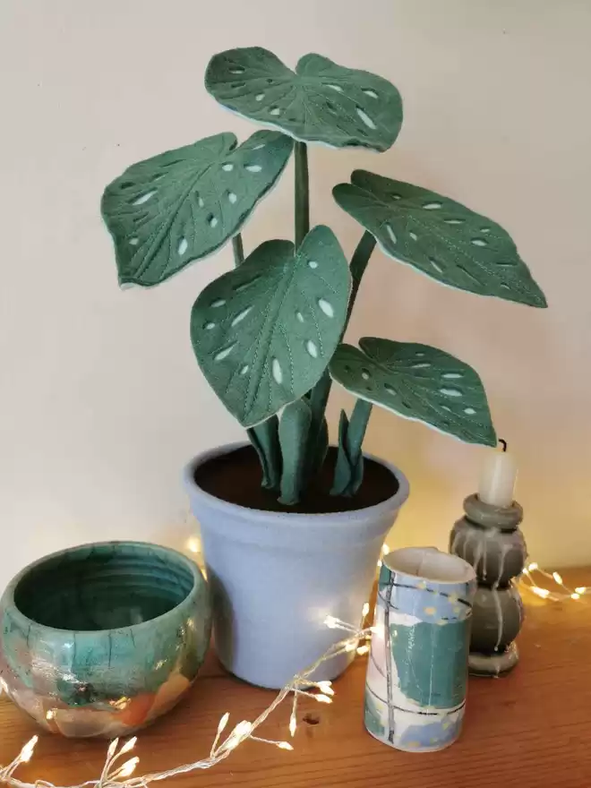 Sage Green Spotty Begonia Felt Faux Potted Houseplant seen with fairy lights.