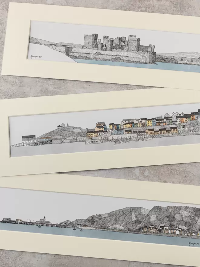 Detailed pen and watercolour drawings of Caerphilly Castle and seafronts at Tenby and Mumbles, in soft white mounts