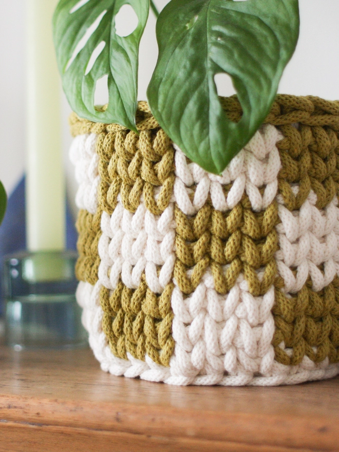 Crocheted rope yarn basket being used as a plant pot cover. Close up image of the yarn.