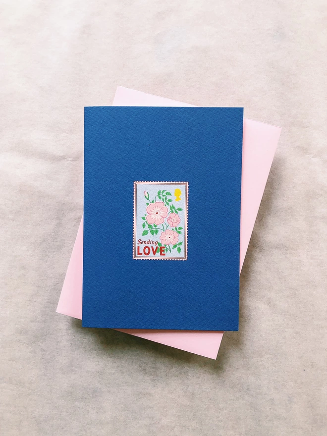 'Sending Love' Floral Stamp Charity Greeting Card illustrated floral rose stamp with royal blue background and powder pink envelope
