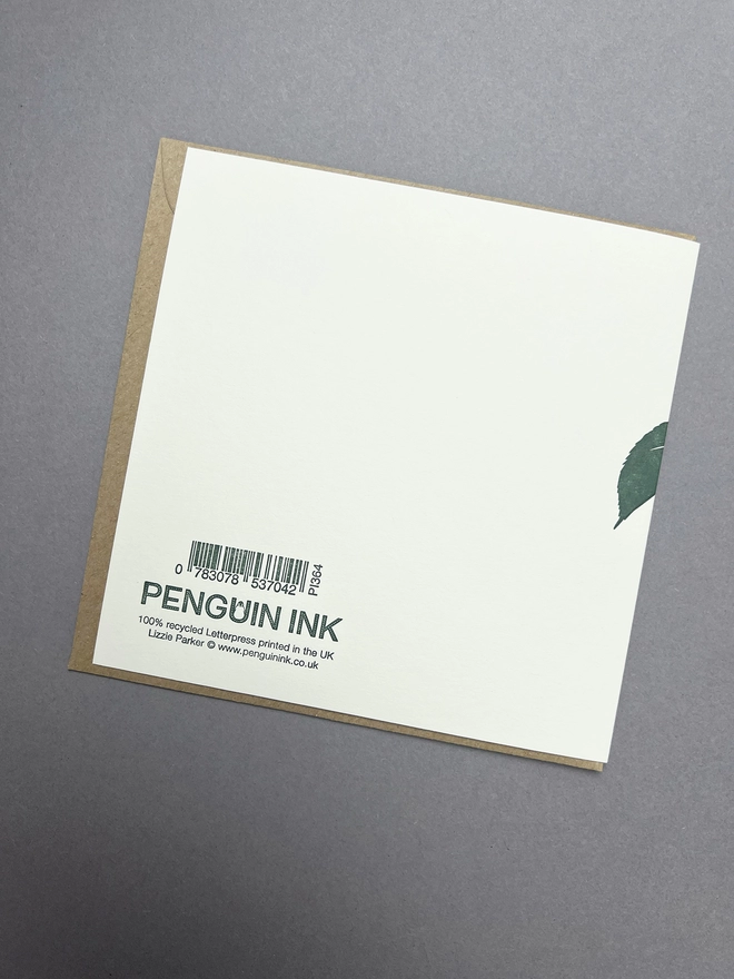 Back of the card with the dark green letterpress printed Penguin Ink logo with barcode