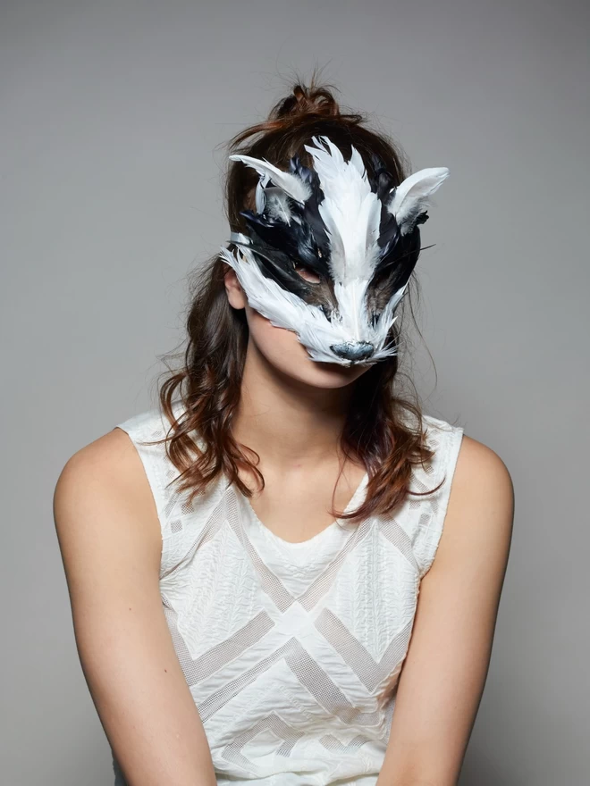 Woman wearing luxury badger masquerade mask down over her face