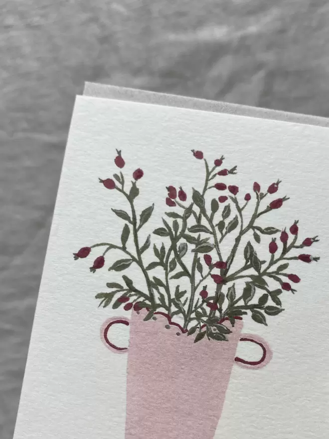 card with rosehips in a pink decorative vase.
