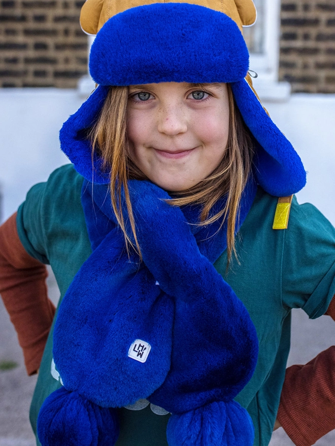 Girl wearing winter faux fur scarf blue