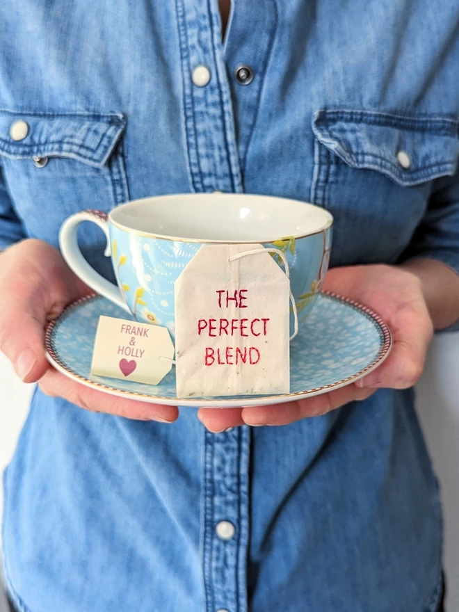 Embroidered The Perfect Blend teabag on cup and saucer 